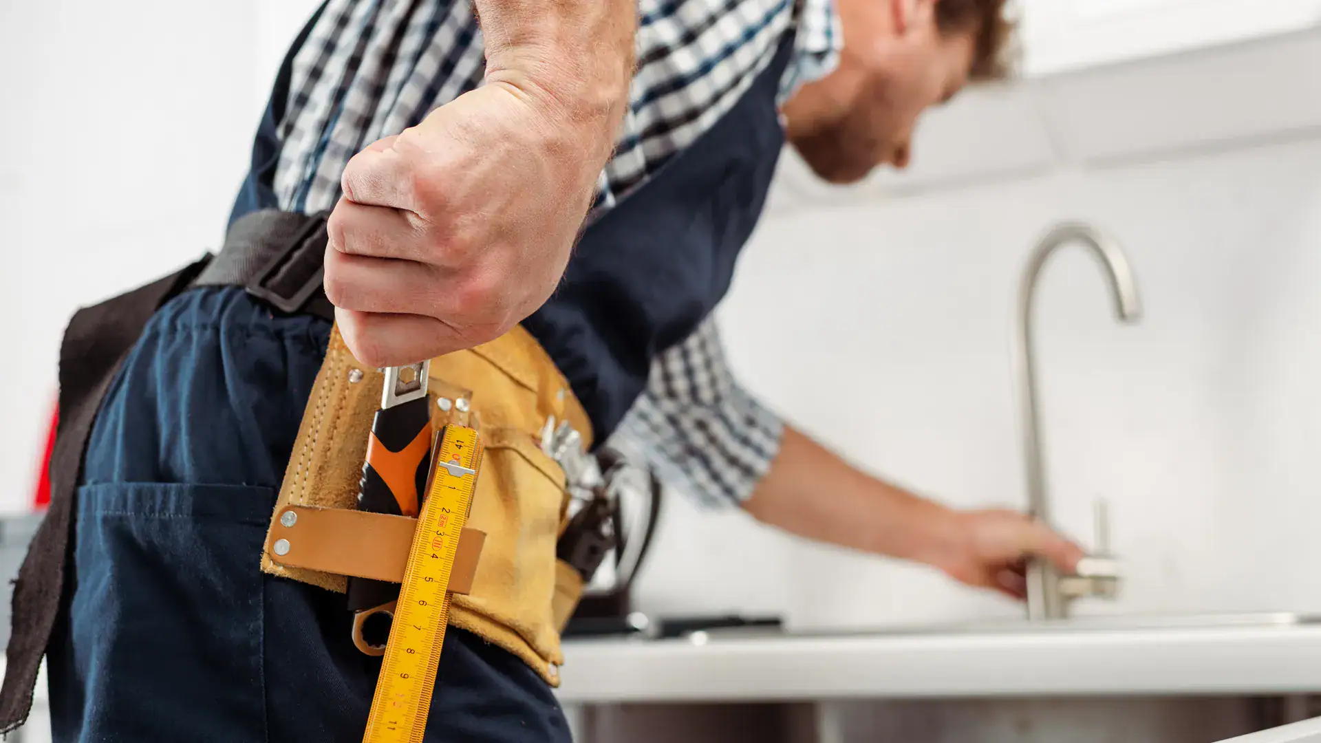 handyman installing a kitchen faucet in Peterborough County